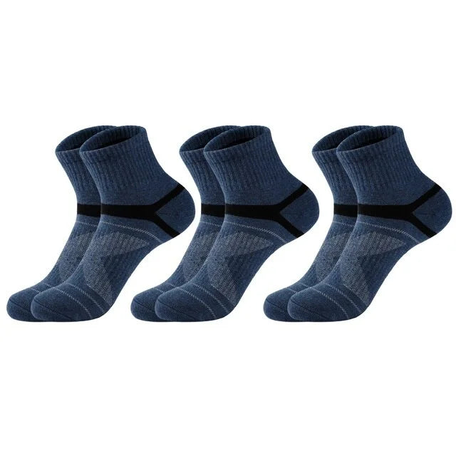 Three pairs of blue socks with black accents on a white background